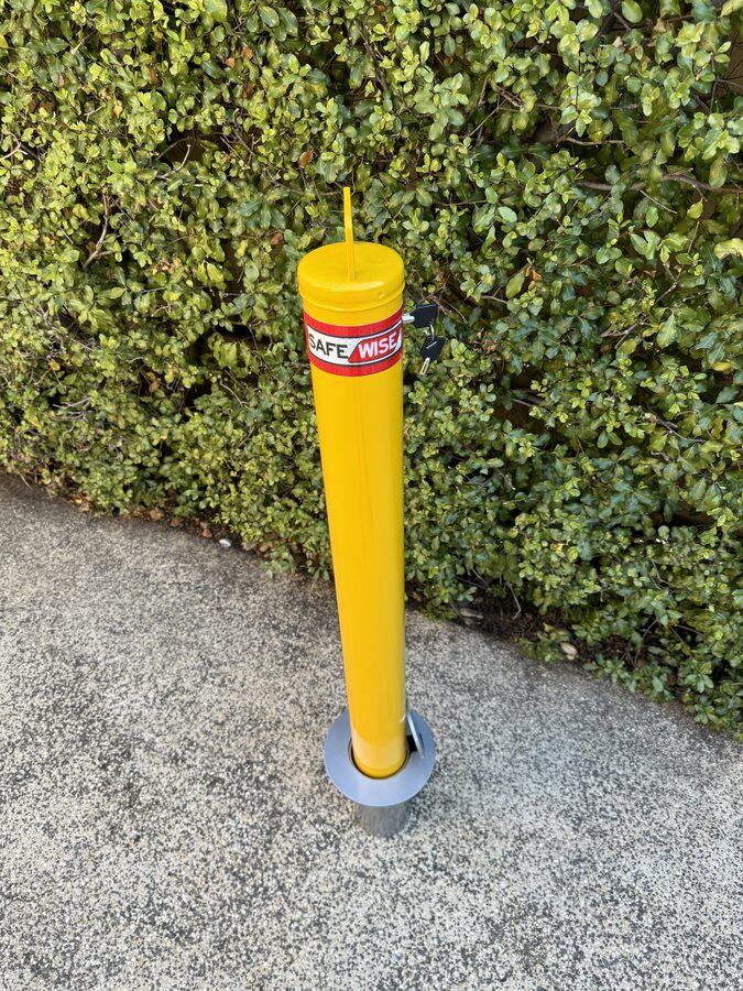 90mm removable key-lock safety bollard seated in its in-ground sleeve