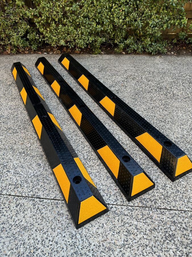 Rubber wheel stops laid out on concrete